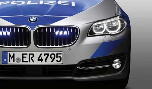 silberner BMW-Polizeiwagen mit blauer auf Motorhaube frontal